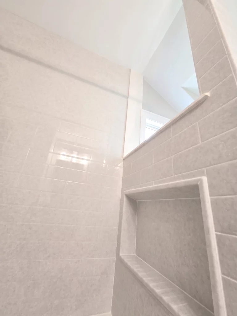 Closeup of Onyx Collection wall panels and recessed caddy as part of a bathroom remodel in Dewitt NY